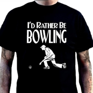 May include: Black t-shirt featuring the white text "I'd Rather Be Bowling" and a white graphic of a bowler. The image also shows the design on shirts in black, white, blue, red, and green.