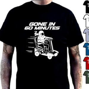May include: Black t-shirt featuring the text "GONE IN 60 MINUTES" and a white graphic of a person on a mobility scooter. The image also shows various other t-shirt colour options.