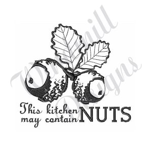 May include: Black and white illustration of two acorns with a leaf. The text "This kitchen may contain NUTS" is below the acorns.
