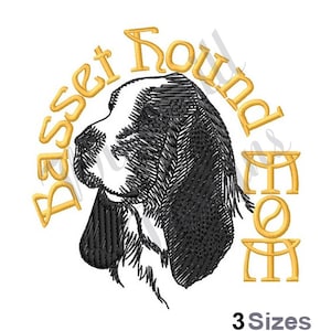 May include: Embroidered design of a Basset Hound head with the text "Basset Hound Mom" in a circular shape. The design is in black and gold.