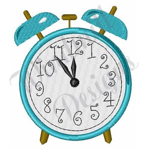 May include: A blue alarm clock with gold accents and black numbers. The clock face shows the time as 12:00.