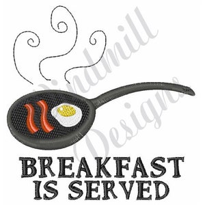 May include: Black and white embroidery design of a frying pan with bacon and an egg, with steam rising from the pan. The text "BREAKFAST IS SERVED" is below the pan.