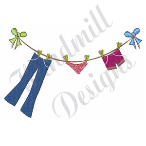 May include: A line of clothes hanging on a clothesline with clothespins. The clothes include a pair of blue jeans, a pink pair of underwear, and a pair of red shorts. There are green and blue bows on either end of the clothesline.