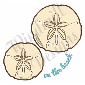 May include: Two brown-outlined sand dollar shells with a white center and a brown five-pointed star design. The text "on the beach" is written in blue cursive below the shells.