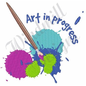 May include: A paintbrush with brown handle and blue bristles is shown with paint splatters in blue, green, and pink. The text "Art in progress" is written in blue.