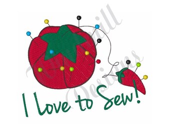 May include: Red pincushion with a green star and a red chili pepper pincushion with the text "I love to Sew!"