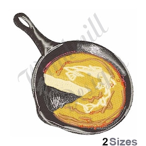 May include: A black cast iron skillet with a yellow pancake inside. The pancake has a brown crust and is slightly burnt on the edges.