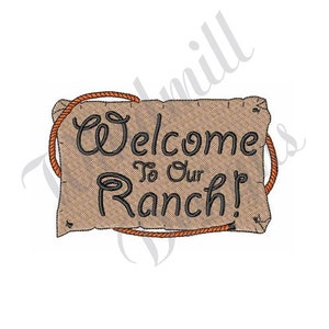 May include: A brown burlap sign with frayed edges and a rope border reads "Welcome to Our Ranch!" in black cursive lettering.