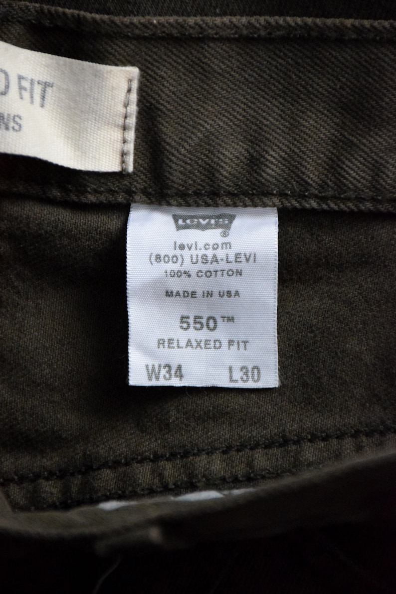May include: White Levi's tag with black text. The tag says "levi.com (800) USA-LEVI 100% COTTON MADE IN USA 550 TM RELAXED FIT W34 L30"