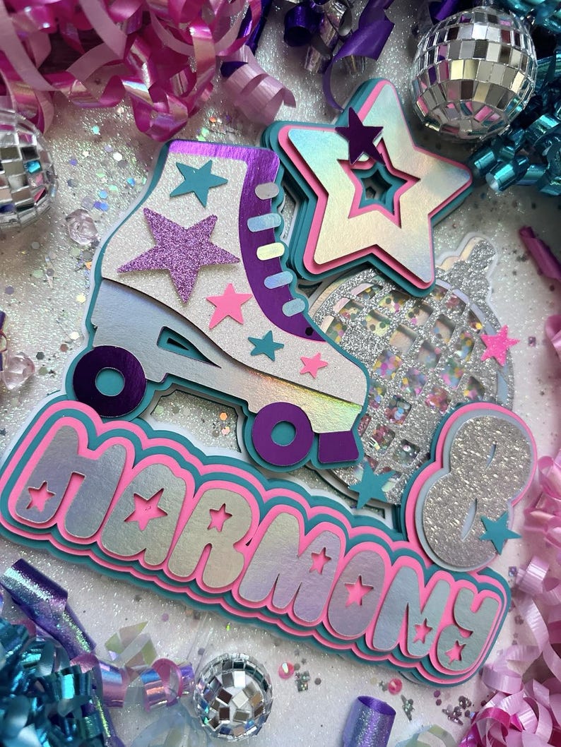 May include: A multi-layered cake topper featuring a roller skate, disco ball, and stars. The roller skate is white with purple and teal accents. The disco ball is silver with glitter. The stars are pink, white, and teal. The words "Harmony 8" are written in a pink, white, and teal font.