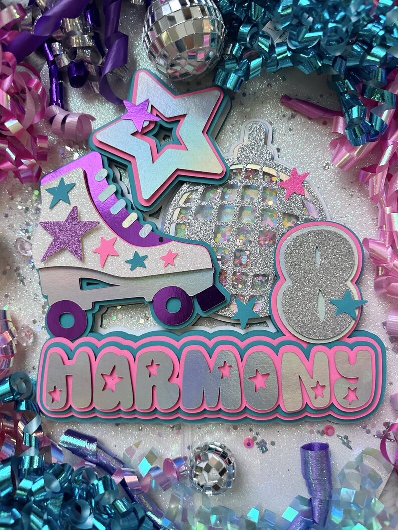 May include: A silver glitter number eight with a silver glitter disco ball and a purple and white roller skate with pink and blue stars. The word "HARMONY" is written in pink and silver glitter letters.
