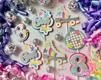 May include: A set of eight cake toppers featuring a roller skate, disco ball, and the numbers 8 and 'Cool' in silver glitter. The toppers are on white sticks and are perfect for a birthday party.