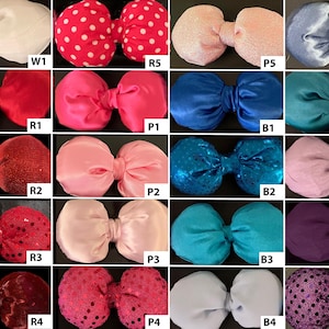 May include: A collection of 20 different bow designs, each with a unique colour and pattern. The bows are made of various materials, including satin, sequins, and glitter. The bows are arranged in a grid pattern, with each bow labelled with a letter and number.