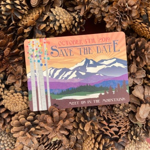 May include: A save the date card with a mountain landscape and the text "October 5th, 2019 Save the Date Meet us in the Mountains".