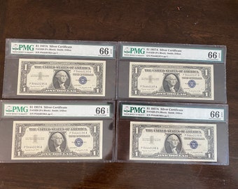May include: Four $1 1957A Silver Certificates graded 66 by PMG. Each certificate features a portrait of George Washington and the text "The United States of America" and "One Dollar".