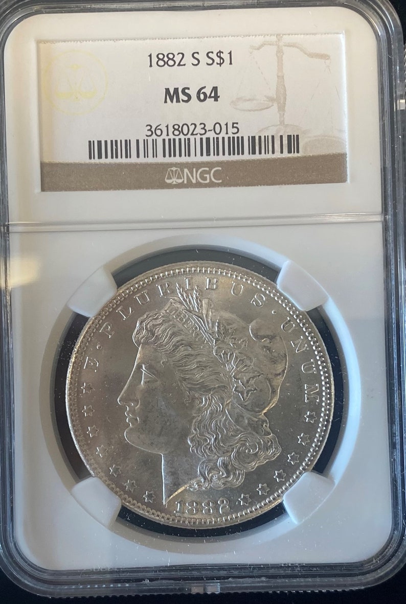 1882 Silver Dollar Coin Housed in a NGC Coin Holder and Grades MS64 Must Have Coin in