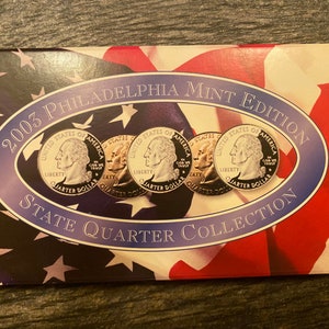 May include: A 2003 Philadelphia Mint Edition State Quarter Collection in a cardboard folder with a red, white, and blue American flag design. The folder contains four silver quarters with the inscription "United States of America" and "Quarter Dollar".