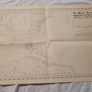 May include: An aged, unfolded map titled "The Miami Herald Hurricane Plotting Map." The map, printed in black ink on aged paper, depicts the southeastern United States, the Caribbean, and the Atlantic Ocean, with grid lines and text.