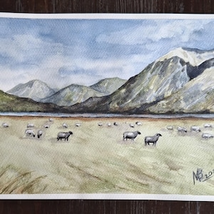 Original watercolor painting.The landscape yf New Zealand. Sheep on the pasture.Hand drawn.