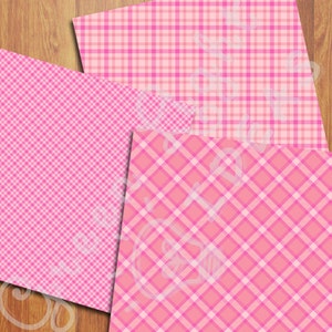 Op de afbeelding: Drie roze en witte geruite papieren. De patronen zijn verschillend, maar alle hebben roze en witte vierkanten.