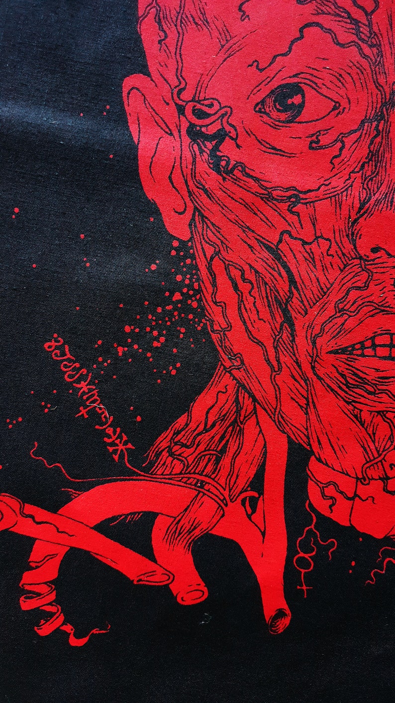 May include: Red and black graphic print of a human face with exposed muscle and veins. The face is contorted in a grotesque expression. The print is on a black background.