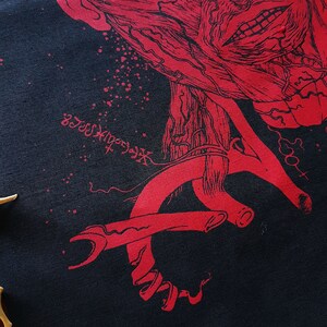 May include: A black fabric with a red anatomical illustration of a face and a red anatomical illustration of a hand. The fabric has a speckled pattern and the text "NecroXxxx" is visible in the lower left corner.