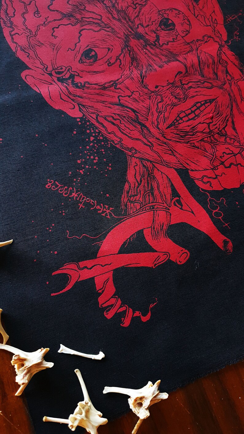 May include: A black fabric with a red anatomical illustration of a face and a red anatomical illustration of a hand. The fabric has a speckled pattern and the text "NecroXxxx" is visible in the lower left corner.