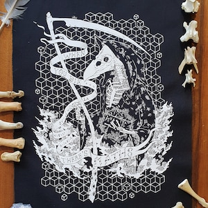 May include: Black and white illustration on a black fabric. The artwork depicts a Grim Reaper-like figure with a bird-like mask, holding a scythe. Text on a banner reads "WHEN YOU DIE THERE'S MATHS".