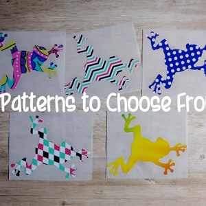 May include: Five different frog designs on white paper. The frogs are in various colours and patterns, including polka dots, stripes, and geometric shapes. The text "5 Patterns to Choose From!" is written below the frogs.