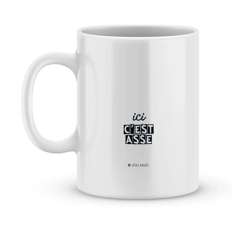 May include: White ceramic mug with black text that reads "ici c'est asse" and "@JOLI MUG".