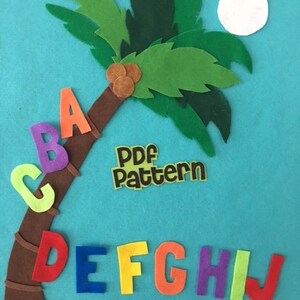 May include: Felt alphabet letters A through J arranged around a brown felt palm tree with green leaves and a white felt moon. The letters are in different colors and the text "PDF pattern" is on a yellow felt rectangle.