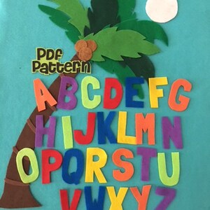 May include: A felt alphabet letter set with the letters A through Z arranged in a semi-circle around a brown felt palm tree with green felt leaves. The letters are in various colors and the words "PDF Pattern" are in a brown rectangle at the top of the image.