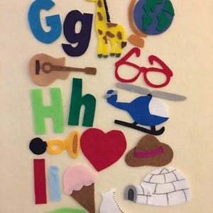 May include: Felt craft set with letters G, H, I, and lowercase versions of each letter.  The set also includes a giraffe, a globe, glasses, a guitar, a helicopter, a heart, a hat, an ice cream cone, an igloo, an iron, and an ice skate.