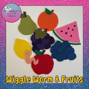 May include: Felt fruit shapes in various colors, including red, green, yellow, orange, purple, and pink. A pink felt worm with a smiling face is on a red apple. The text "Wiggle Worm & Fruits" is at the bottom of the image.
