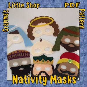 May include: A set of seven felt nativity masks for a Christmas play or craft project. The masks include a brown-haired angel with a yellow halo, a brown-skinned wise man with a red turban, a brown-skinned wise man with a green crown, a brown-skinned wise man with a blue turban, a brown-skinned Joseph with a blue robe, a white baby Jesus, and a brown-skinned Mary with a blue robe. The masks are all cut out and ready to be used.