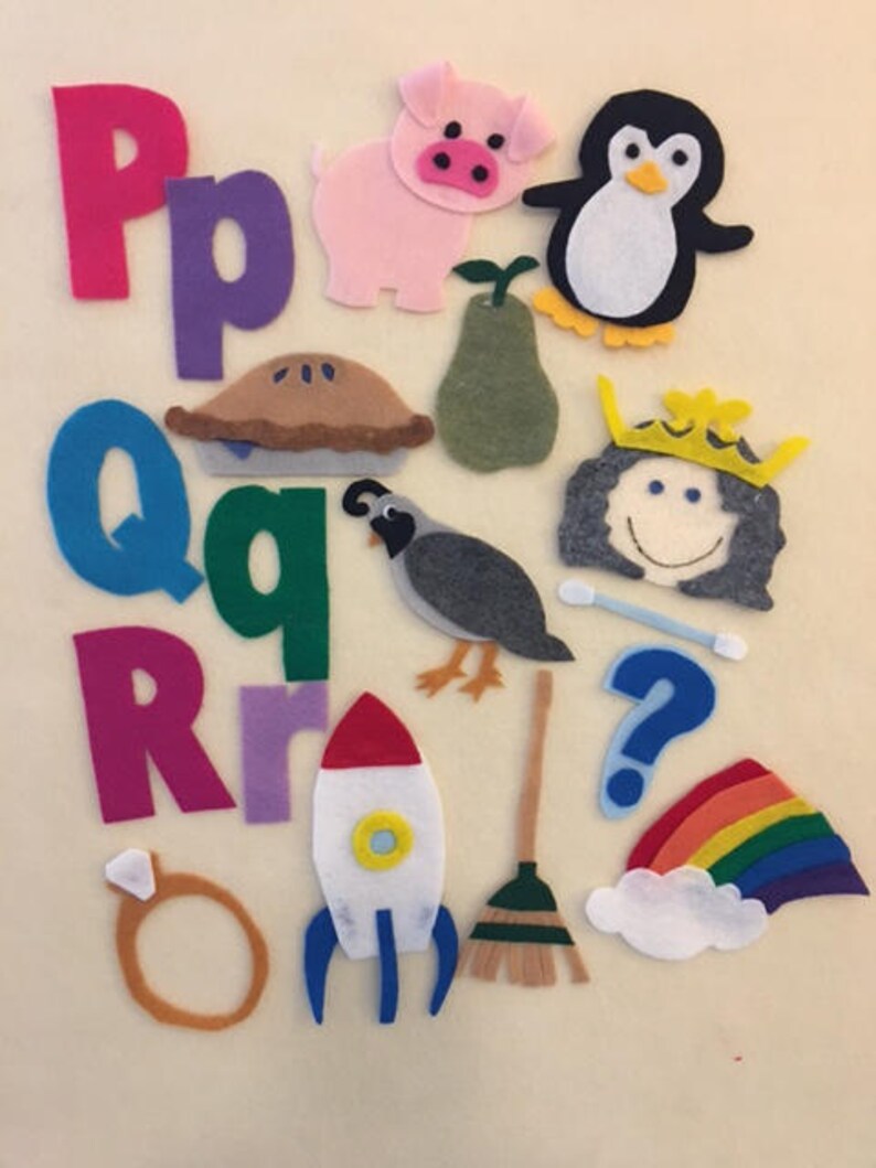 May include: Felt alphabet letters, numbers, and objects, including a pink pig, a penguin, a pear, a pie, a quail, a queen, a question mark, a rocket, a broom, a ring, a rainbow, and a cloud.