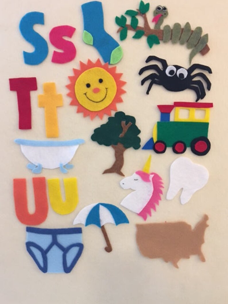 May include: Felt craft letters S, T, and U, along with various felt images including a sock, sun, spider, tree, train, bathtub, unicorn, tooth, umbrella, underwear, and the outline of the United States.