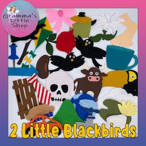 May include: A collection of felt cutouts in various shapes and colors, including blackbirds, a skull, a bull, and a toucan. Other shapes include a pink bow, a flower, and a blue mug. The text "2 Little Blackbirds" is at the bottom.
