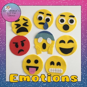 May include: A collection of felt emoji faces in various expressions, including sad, crying, angry, and happy. The word "Emotions" is displayed in yellow block letters. The image is from "Gramma's Little Shop".