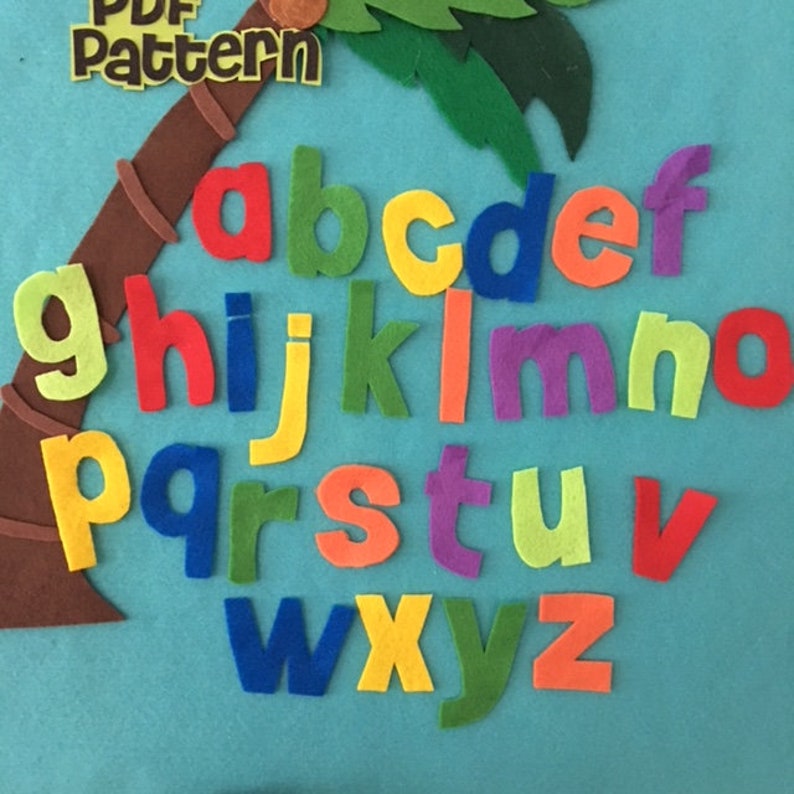 May include: A felt alphabet set with letters in various colors, including red, green, yellow, blue, orange, and purple. The letters are arranged in alphabetical order on a blue background.