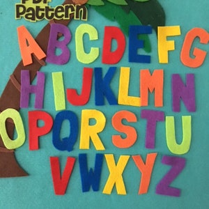 May include: A set of felt alphabet letters in various colors, including red, blue, green, yellow, orange, and purple. The letters are arranged in alphabetical order and are perfect for educational purposes.