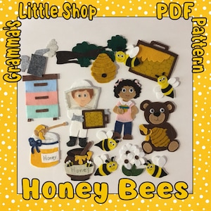 May include: Felt craft pattern for a honey bee themed play set. The pattern includes a beekeeper, a girl, a bear, a beehive, honey pots, and bees. The pattern is available as a PDF download. "Grandma's Little Shop PDF Pattern"