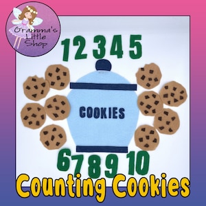 May include: A felt counting activity with a blue cookie jar and ten brown chocolate chip cookies. The numbers 1 to 10 are displayed in green felt. The text "Counting Cookies" is displayed in yellow felt.