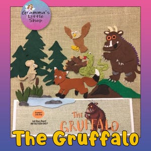 May include: A felt story board depicting characters from "The Gruffalo". The scene includes a brown Gruffalo, a fox, an owl, a mouse, a snake, and trees. The text "The Gruffalo" is displayed in orange letters. The shop's logo is in the upper left corner.