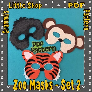 May include: Three felt animal masks: a grey lion, a brown monkey, and an orange tiger with black stripes. The masks are displayed on a blue background. Text reads "Zoo Masks - Set 2" and "PDF Pattern".