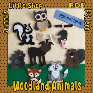 Pode incluir: Um conjunto de padrões de animais da floresta de feltro para artesanato. Os padrões incluem um alce, uma coruja, uma raposa, um lobo, um gambá, um ouriço, um castor e um gambá pendurado em um galho. Os padrões estão disponíveis para download em PDF. O texto "Little Shop Grandma's PDF Pattern Woodland Animals" está na imagem.