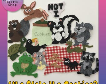 May include: A collection of felt animal cutouts including a rabbit, beaver, turtle, crow, frog, mouse, skunk, squirrel, snake, ant, and raccoon, alongside a felt cookie jar, a red and white checkered cloth, and text reading NOT I.