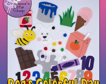 May include: A felt craft set featuring a white dog with colorful spots, a bee, ice cream, juice box, paint, grass, chocolate, a crayon, and numbers. The text "Dog's Colorful Day" is displayed at the bottom.
