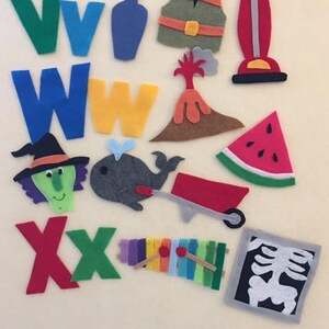 May include: Felt letter squares in green, blue, yellow, and red, with felt images of a vase, vest, vacuum cleaner, volcano, watermelon, witch, whale, wheelbarrow, xylophone, and an x-ray.