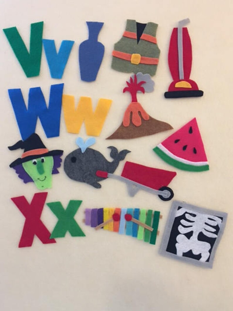 May include: Felt letter squares in green, blue, yellow, and red, with felt images of a vase, vest, vacuum cleaner, volcano, watermelon, witch, whale, wheelbarrow, xylophone, and an x-ray.